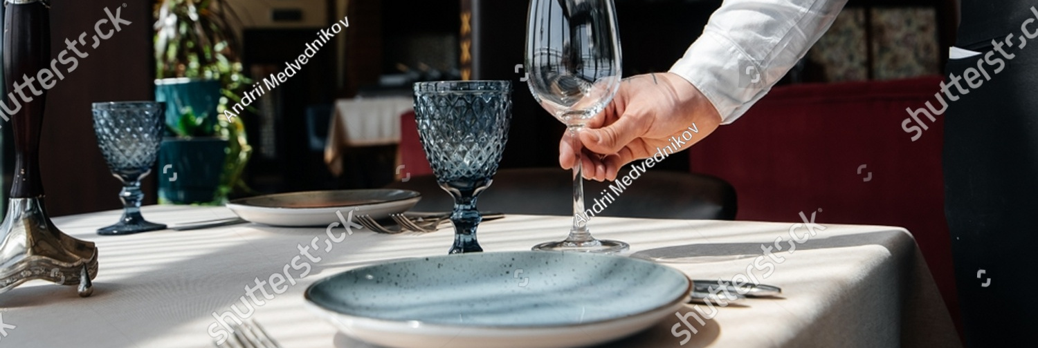 stock photo a young waiter in a stylish uniform is engaged in serving the table in a beautiful gourmet 2205995303