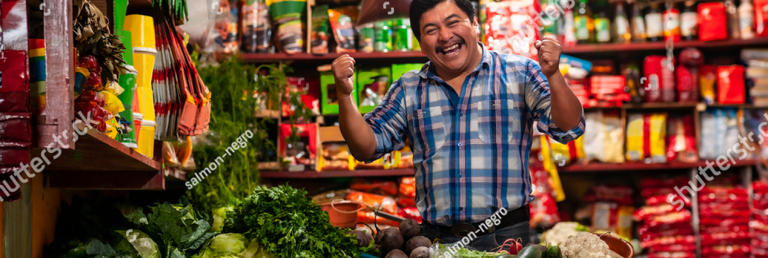 stock photo grocery store in guatemala with successful man celebrating standing in a boxing position 1693673260