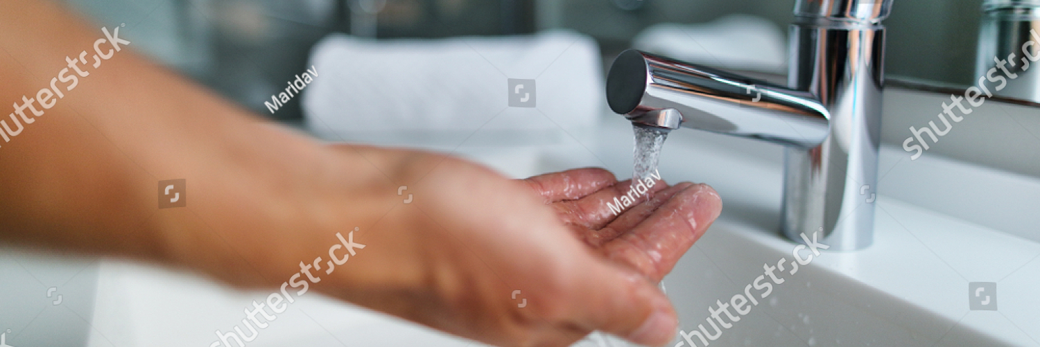 stock photo man washing hands in bathroom sink at home checking temperature touching running water with hand 793670761